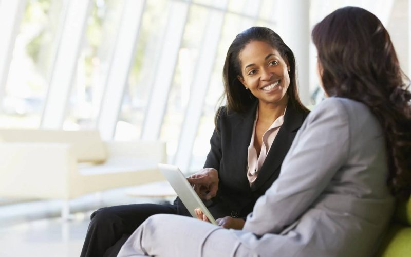 Businesswomen-With-Digital-Tablet-Sitting-In-Modern-Office-1940x1244
